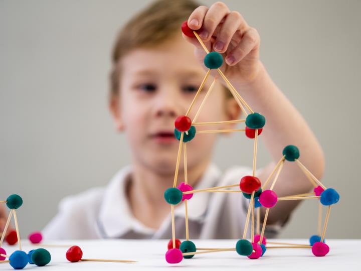 boy-playing-with-colorful-atoms-game-table.jpg