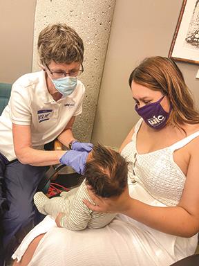 Marisol Mendez gets instruction at the Baby Cafe. Photo by Edrieana Martinez, CAPK